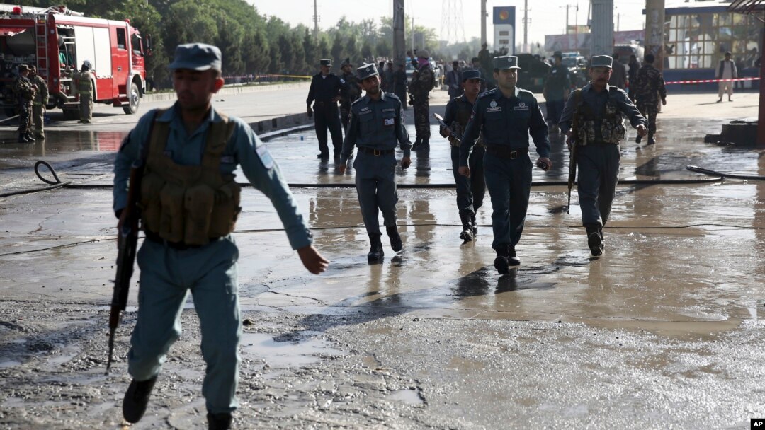 FILE - Afghan police soldiers inspect the site of a suicide attack in Kabul, Afghanistan, Monday, June 20, 2016.
