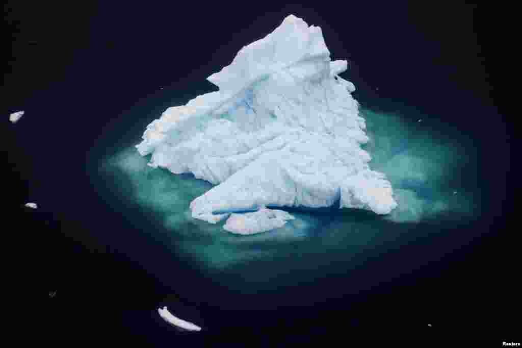 An iceberg floats in a fjord near the town of Tasiilaq, Greenland, in this photo taken June 24, 2018. A team of NASA scientists traveled to Greenland to study exactly how warming oceans are melting the island's ice.