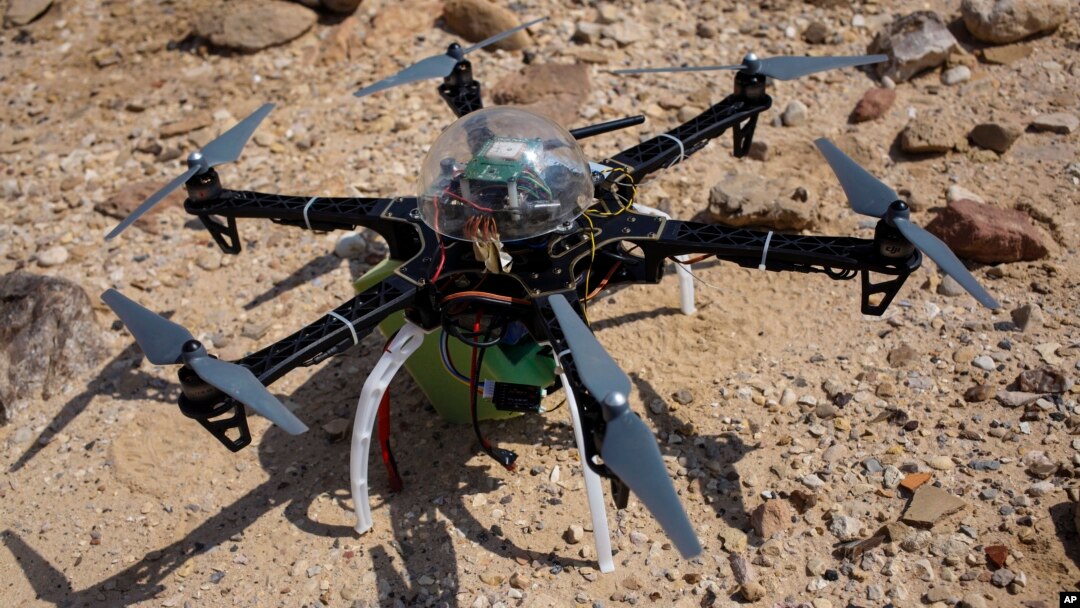 Six-bladed drone casts shadow on a heavily looted 5,000-year-old cemetery, known as Fifa, in southern Jordan, March 19, 2015.