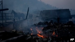 Horses stand near stables consumed by the Bridge Fire in Wrightwood, California, Sept. 11, 2024.
