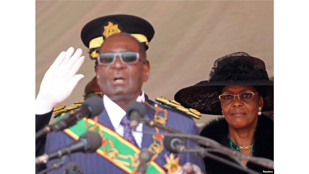 FILE - Zimbabwe President Robert Mugabe (L) and his wife Grace look on during the Defense Force's 36th Anniversary celebrations in the capital Harare, Zimbabwe, Aug. 9, 2016.