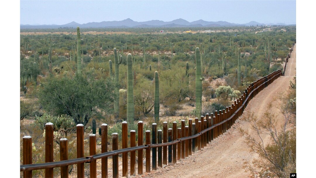 FILE - The international border line made up of bollards separating Mexico, left from the United States, in the Organ Pipe National Monument near Lukeville, Ariz., Feb. 17, 2006.