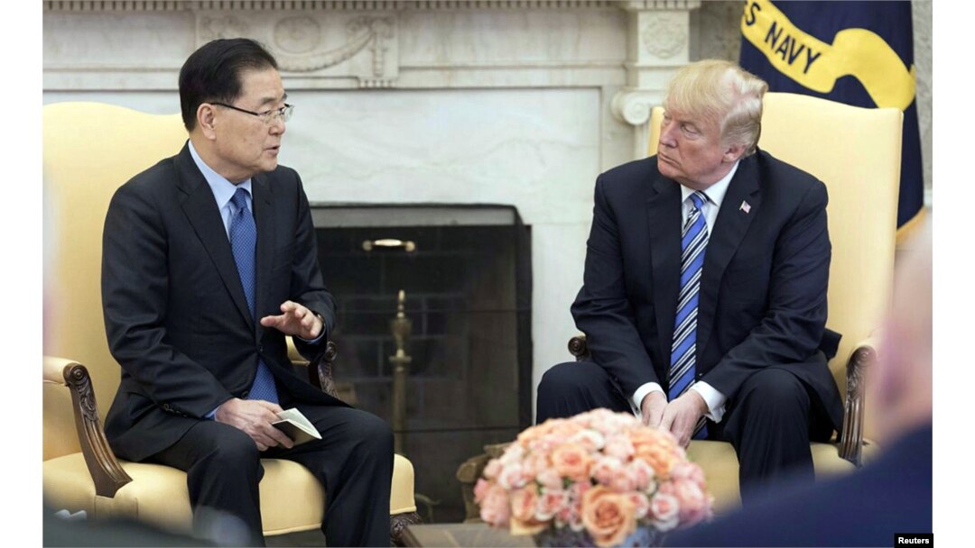 South Korea's national security chief Chung Eui-yong briefs U.S. President Donald Trump at the Oval Office about his visit to North Korea, in Washington, March 8, 2018.