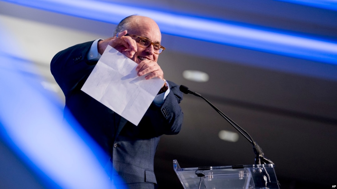 Rudy Giuliani, an attorney for President Donald Trump, pretends to tear a piece of paper as he speaks about the Iran nuclear agreement at the Iran Freedom Convention for Human Rights and Democracy at the Grand Hyatt, May 5, 2018, in Washington.
