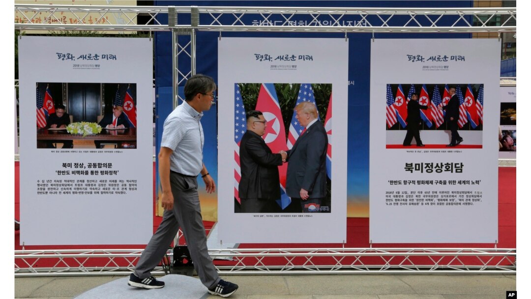 FILE - Photos of the summit between U.S. President Donald Trump and North Korean leader Kim Jong Un are displayed during a photo exhibition to wish for peace on the Korean Peninsula in Seoul, South Korea, Sept. 19, 2018.