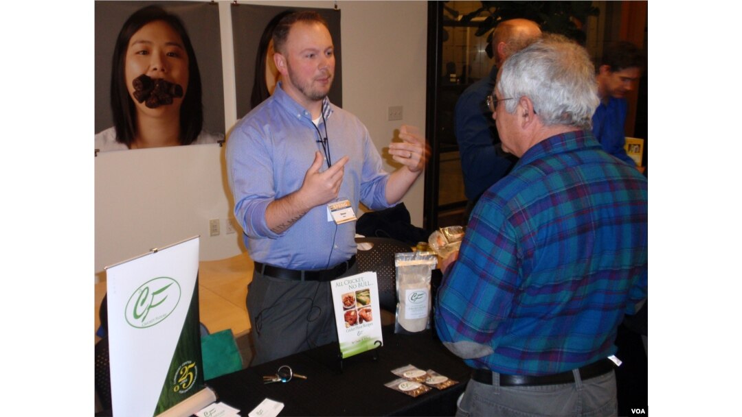 Cricket Flours Co-Founder Omar Ellis offers product samples in Portland last month. (Tom Banse)