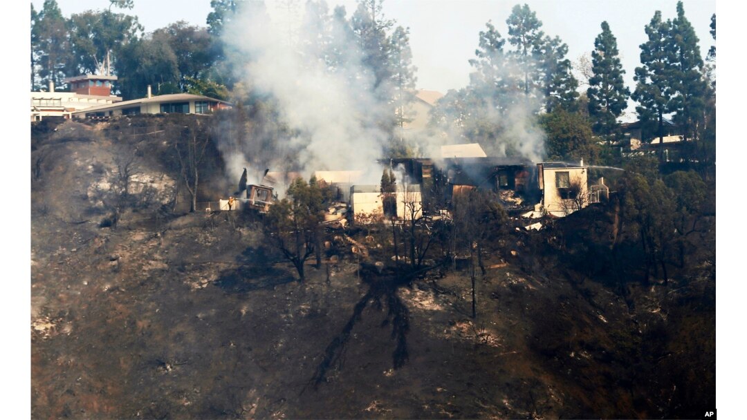 A multimillion-dollar home is a smoldering ruin after a wildfire swept through the Bel Air district of Los Angeles, Dec. 6, 2017.