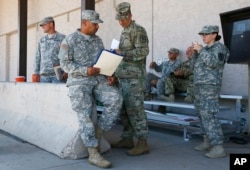 Arizona National Guard soldiers receive their reporting paperwork prior to deployment to the Mexico border at the Papago Park Military Reservation in Phoenix, April 9, 2018.