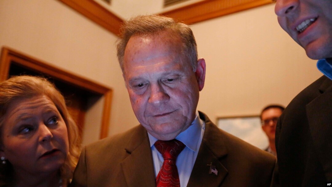 Republican U.S. Senate candidate Roy Moore, center, looks at election returns with staff during an election-night watch party at the RSA activity center, Dec. 12, 2017, in Montgomery, Ala.