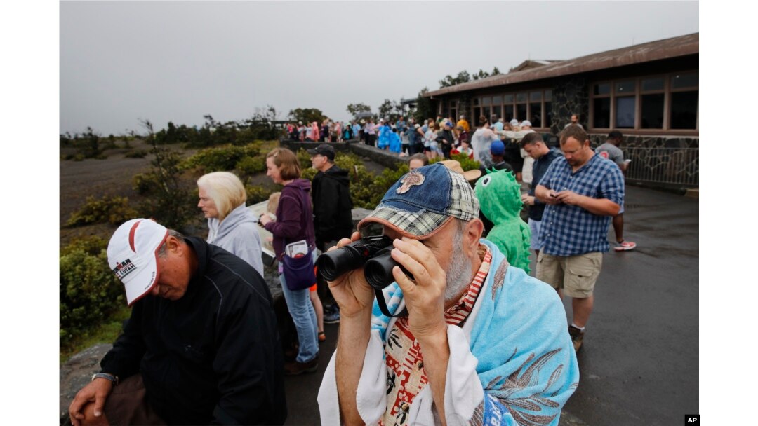 Visitors view Kilauea's summit crater outside the Jaggar Museum in Volcanoes National Park, Hawaii, May 10, 2018. The park is closing Friday because of the threat of an explosive volcanic eruption.