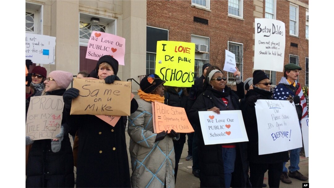 Protesters gather outside Jefferson Middle School in Washington, Feb. 10, 2017, where Education Secretary Betsy DeVos paid her first visit as education secretary in a bid to mend fences with educators after a bruising confirmation battle.
