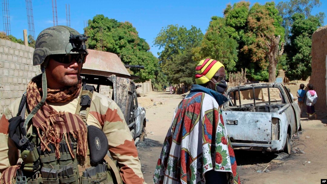 FILE - A French soldier secures a perimeter on the outskirts of Diabaly, Mali, Jan. 21, 2013.