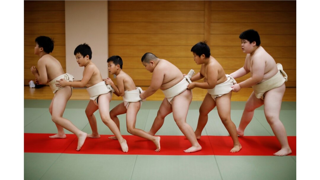 Kyuta Kumagai, 10, warms up with other boys before training, at Komatsuryu sumo club in Tokyo, Japan, August 23, 2020. "It is fun to beat people older than me," said Kyuta. (REUTERS/Kim Kyung-Hoon)