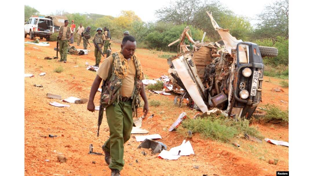 A Kenyan security person walks past a police vehicle damaged by a blast killing Kenyan police officers at the Garissa county, eastern Kenya, May 24, 2017.