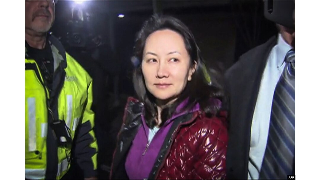FILE - This TV image provided by CTV to AFP shows Huawei Technologies Chief Financial Officer Meng Wanzhou as she exits the court registry following the bail hearing at British Columbia Superior Courts in Vancouver, British Columbia, Dec. 11, 2018.