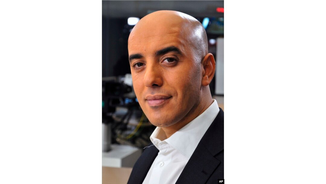 FILE - Notorious French gangster Redoine Faid poses for a photo prior to an interview with French TV channel, LCI, in Boulogne-Billancourt, outside Paris, France, Nov. 22, 2010.