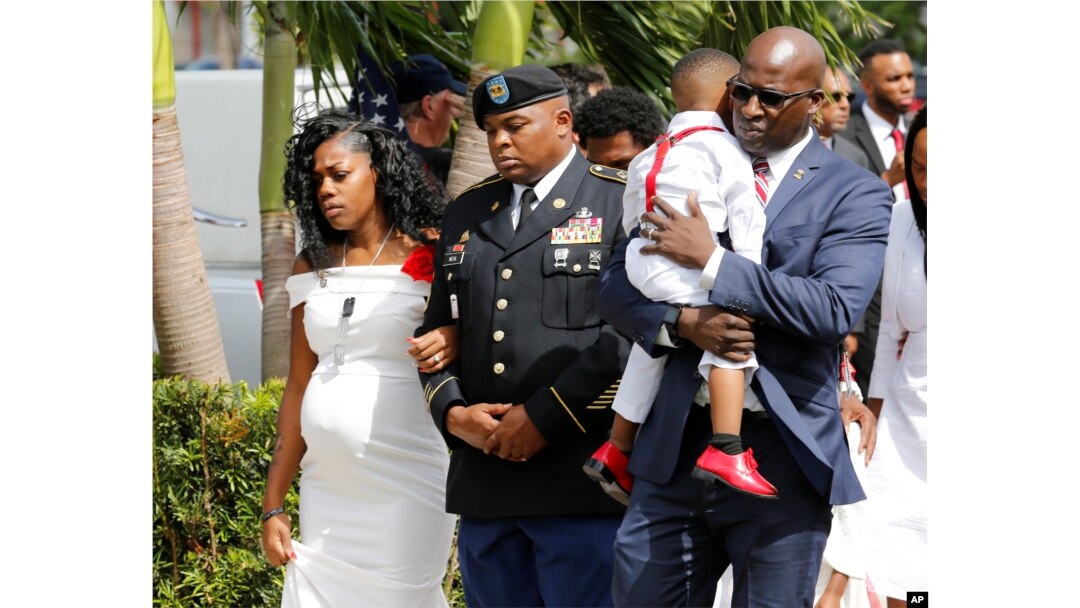 Myeshia Johnson, widow of U.S. Army Sergeant La David Johnson, who was among four special forces soldiers killed in Niger, is escorted into his graveside service in Hollywood, Florida, Oct. 21, 2017.