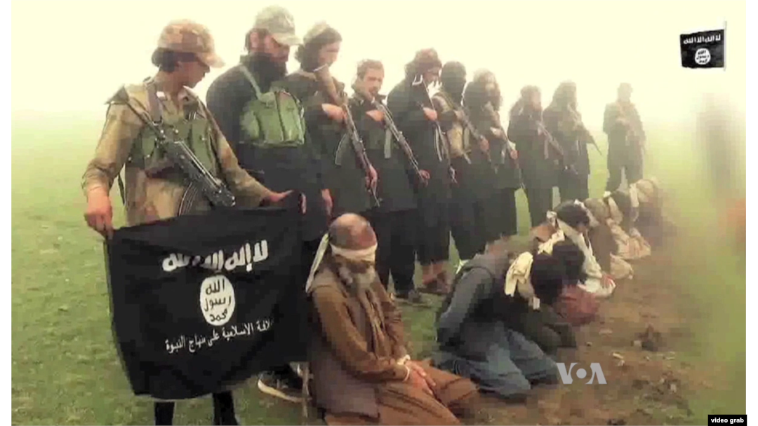 FILE - An image from a purported Islamic State group video showing captives. The recent beheadings of members of the minority Shi’ite Hazara ethnic community sparked protests in Kabul.