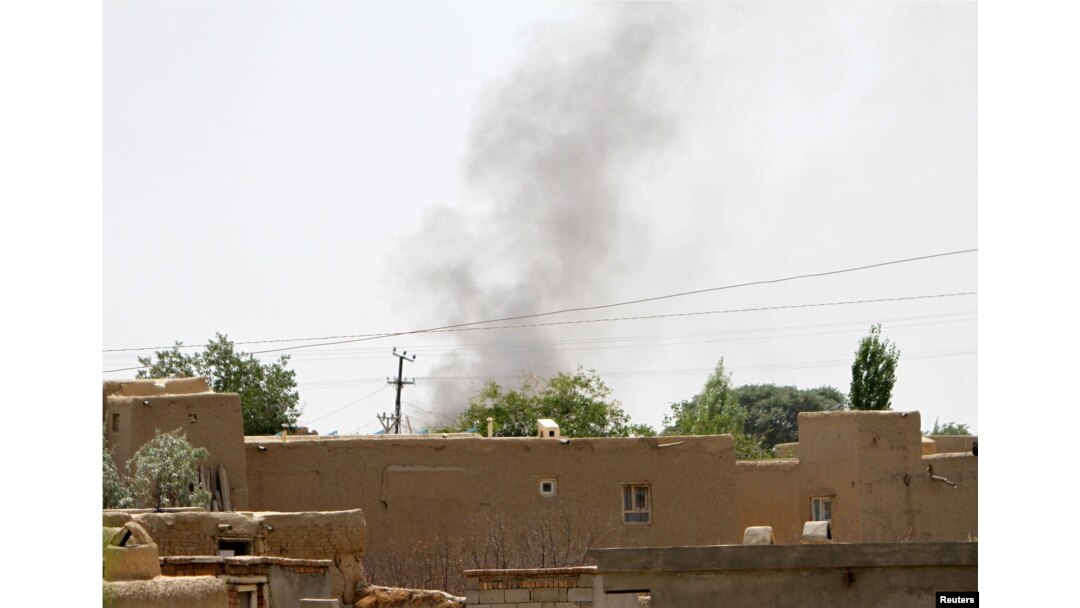 FILE - Smoke rises from a residential area where gun battle is going on between Taliban and Afghan forces in Ghazni province, Afghanistan Aug. 10, 2018.