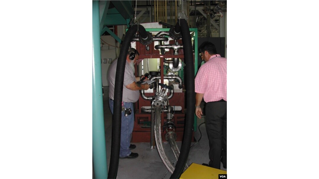 Engineers check the Green Machine, which converts waste heat into electricity, at Southern Methodist University in Dallas. (Courtesy SMU)