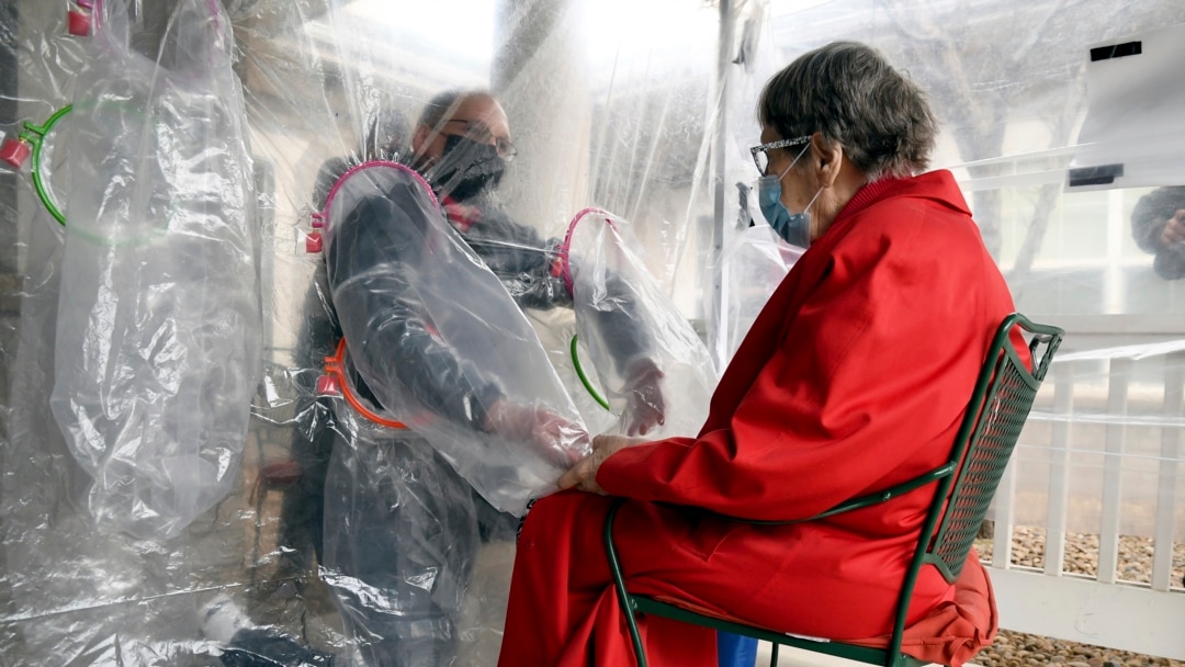 The tent includes a construction-grade plastic barrier with built-in plastic sleeves to prevent the spread of the coronavirus, in Louisville, Colorado, on Wednesday, Feb. 3, 2021. (AP Photo/Thomas Peipert)