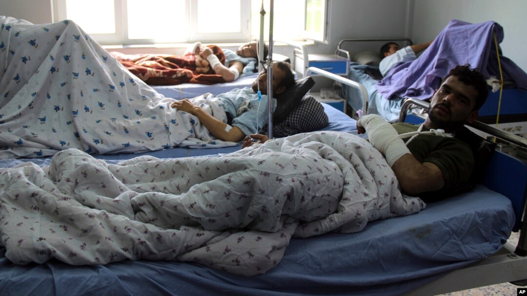 Injured men receive treatment at a hospital after a clash between Taliban and security forces in Kunduz province, Afghanistan, April 13, 2019.