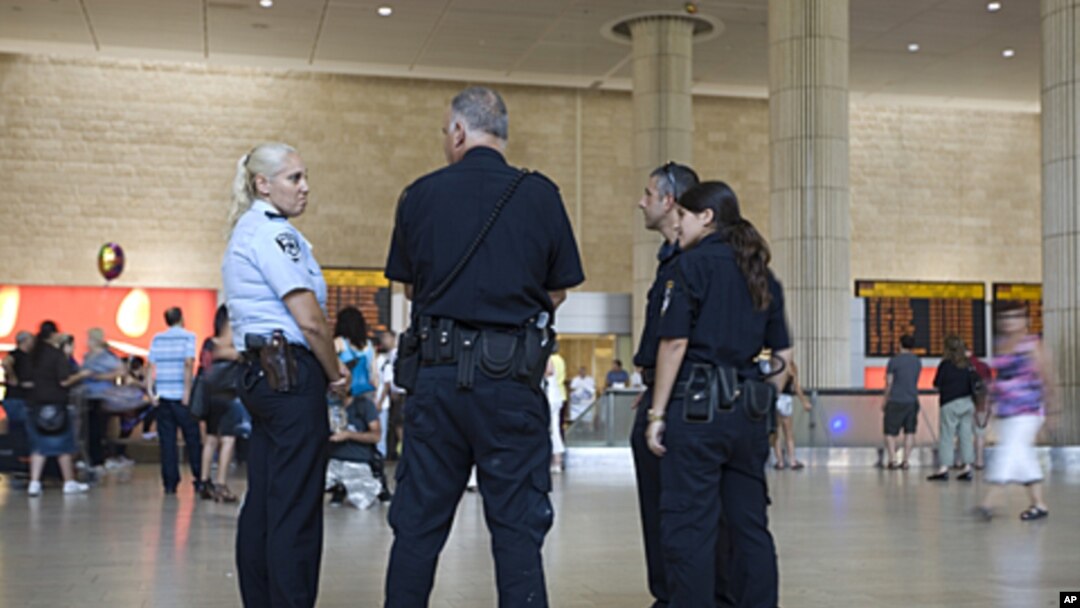 Israeli police officers stand guard at Ben Gurion international airport near Tel Aviv , July 7, 2011