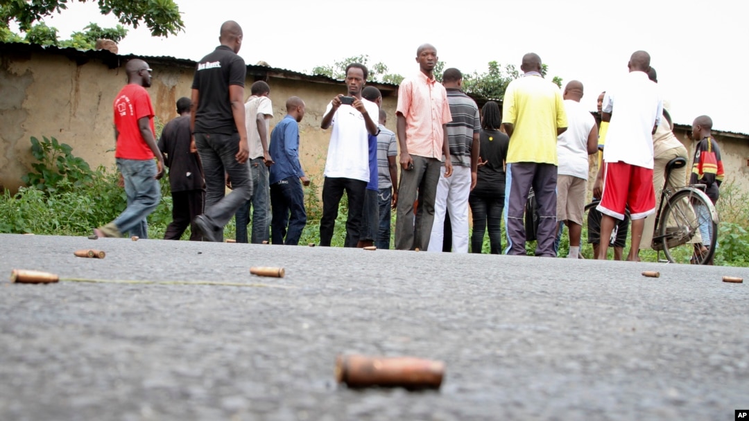 A man takes a picture of spent bullet casings lying on a street in the Nyakabiga neighborhood of Bujumbura, Burundi, Dec. 12, 2015. The country has been in a yearlong crisis, which grew out of President Pierre Nkurunziza's decision to seek a third term in office.