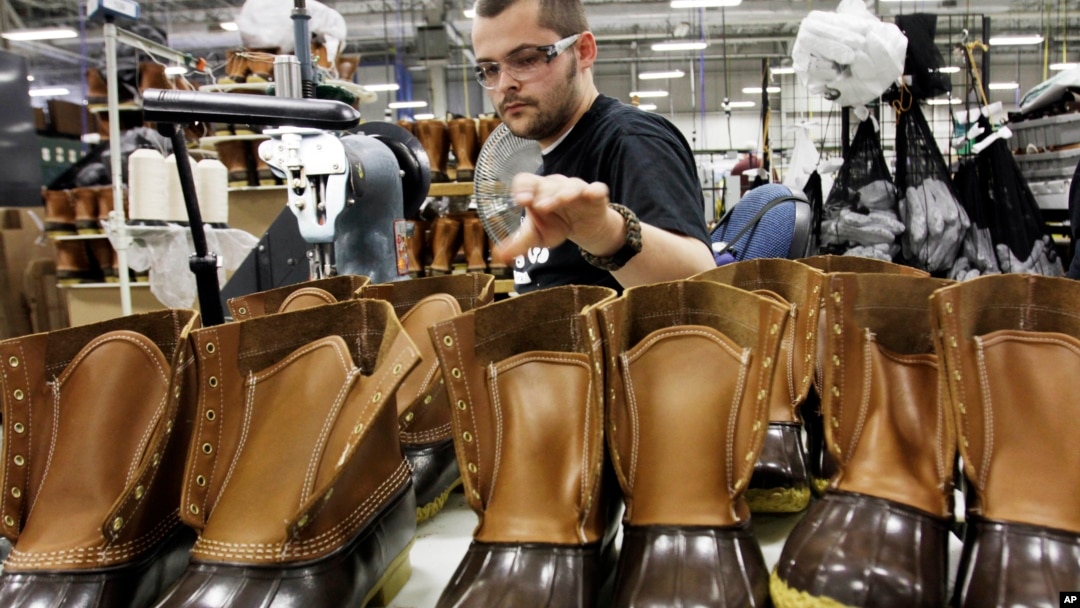 FILE - Eric Rego stitches boots in the facility where L.L. Bean boots are assembled in Brunswick, Maine, Dec. 14, 2011.
