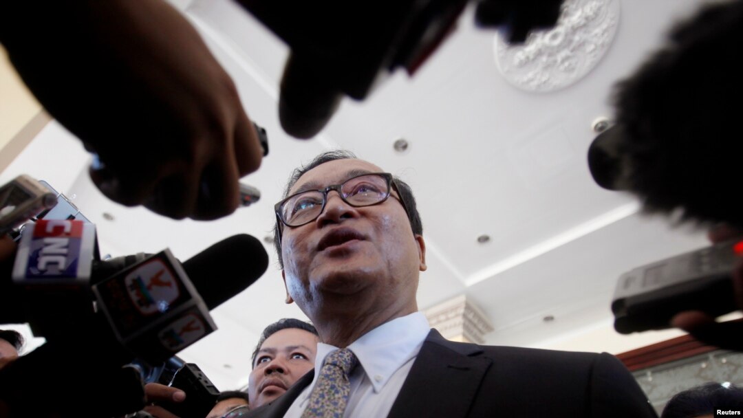 FILE - Sam Rainsy, President of the Cambodia National Rescue Party (CNRP), speaks to media after a meeting at the National Assembly in central Phnom Penh.