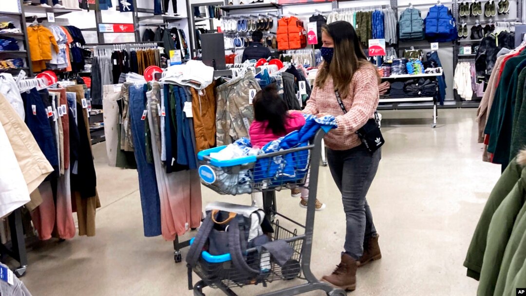 FILE - Consumers shop at a retail store in Vernon Hills, Ilinois., Nov. 13, 2021. The Federal Reserve’s goal in raising its benchmark inflation rate is to curb consumer demand and, correspondingly, curtail inflation.