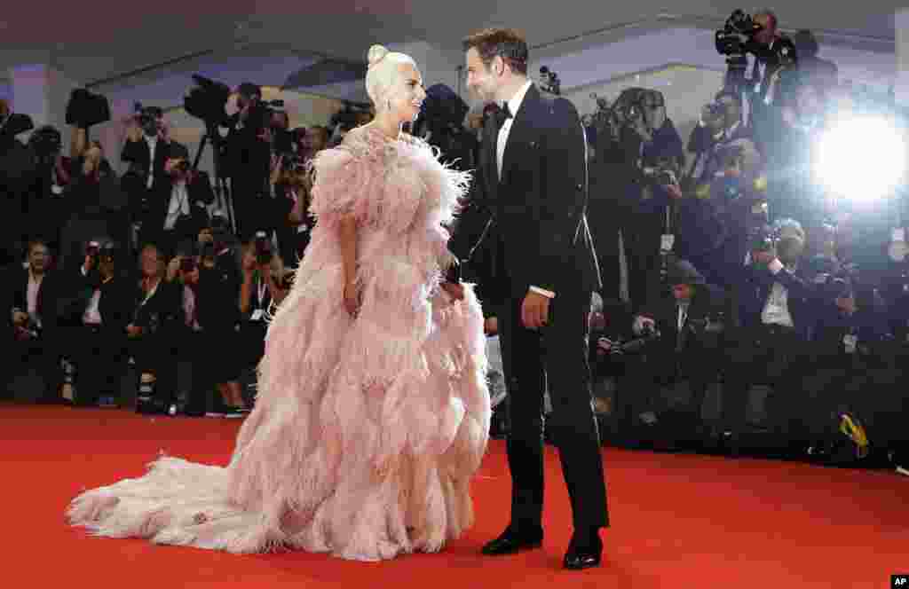 Actress and singer Lady Gaga, left, and actor Bradley Cooper pose for photographers upon arrival at the premiere of the film 'A Star Is Born' at the 75th edition of the Venice Film Festival in Venice, Italy.