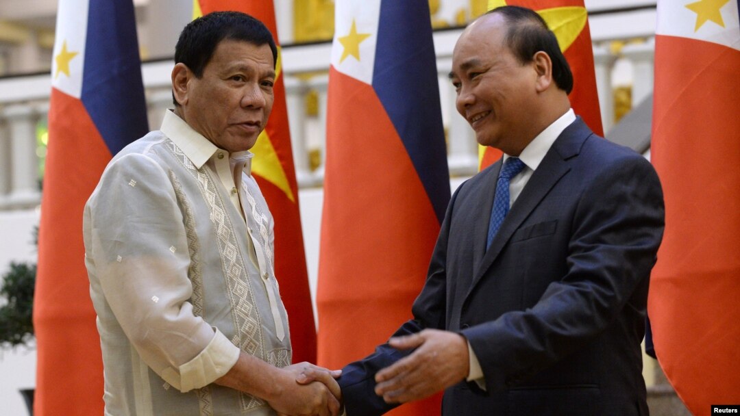 Philippines' President Rodrigo Duterte, left, greets Vietnamese Prime Minister Nguyen Xuan Phuc as they meet at Phuc's Cabinet Office in Hanoi, Vietnam, Sept. 29, 2016. Both nations are attempting to modernize their militaries.