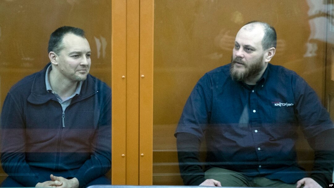 The former chief of the cybercrime department at Russia's main domestic security agency Sergei Mikhailov, left, and the former employee of Kaspersky Lab cybersecurity firm Ruslan Stoyanov attend a hearing in a court in Moscow, Russia, Feb. 26, 2019.