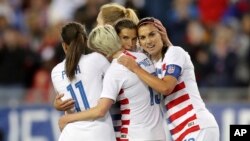 FILE - United States' Tobin Heath, second from right, is congratulated on her goal by Mallory Pugh (11), Megan Rapinoe and Alex Morgan (13) in 2019. (AP Photo/Mike Carlson)