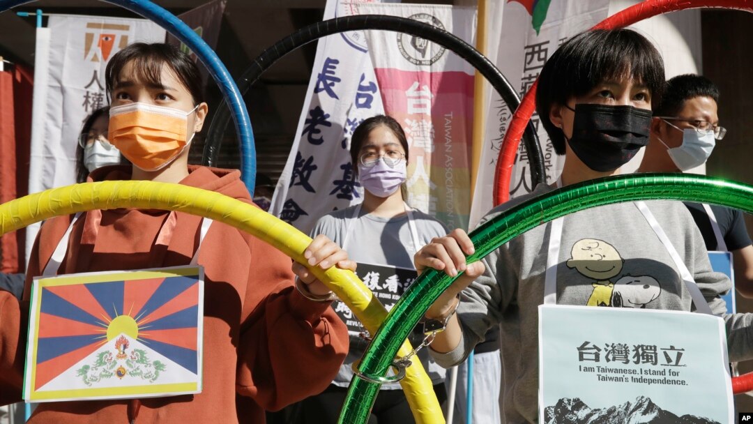 FILE - Human rights groups gather to raise their slogan calling for a boycott of the Beijing Winter Olympics 2022, in Taipei, Taiwan, Jan. 26, 2022.