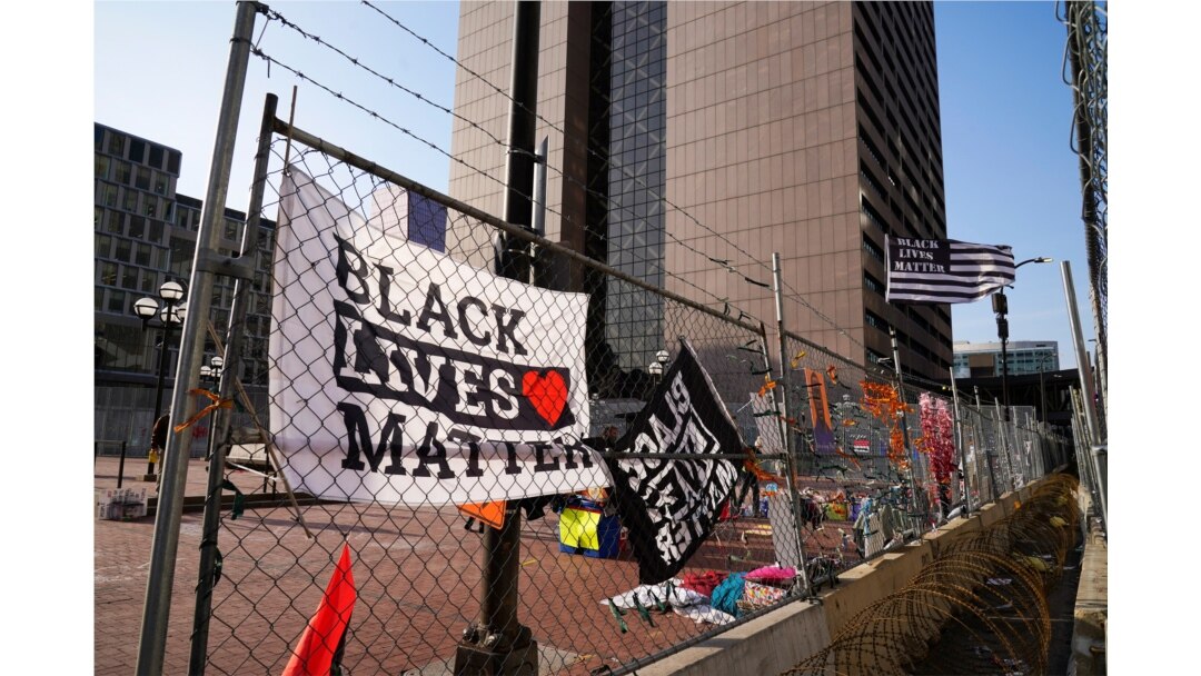 Black Lives Matter flags fly and line the fence surrounding the Hennepin County Government Center, April 2, 2021 in Minneapolis, where the trial for former Minneapolis police officer Derek Chauvin continues.