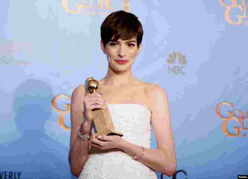 Anne Hathaway holds the award she won for Best Supporting Actress in a Motion Picture, Comedy or Musical for her work in "Les Miserables" backstage at the 70th annual Golden Globe Awards in Beverly Hills, California, January 13, 2013.