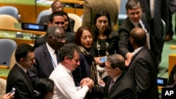 Cuba's Foreign Minister Bruno Rodriguez, center right, is congratulated by fellow U.N. delegates after a vote on the annual draft resolution calling for an end to the U.S.-led five-decade embargo against the Caribbean nation, in the United Nations General