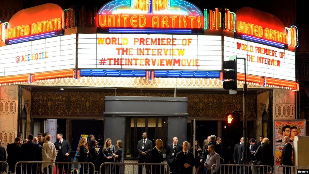Security guards stand behind bicycle rails at the entrance of United Artists theater during premiere of the film "The Interview" in Los Angeles, California December 11, 2014. REUTERS/Kevork Djansezian (UNITED STATES - Tags: ENTERTAINMENT) - RTR4HPO5