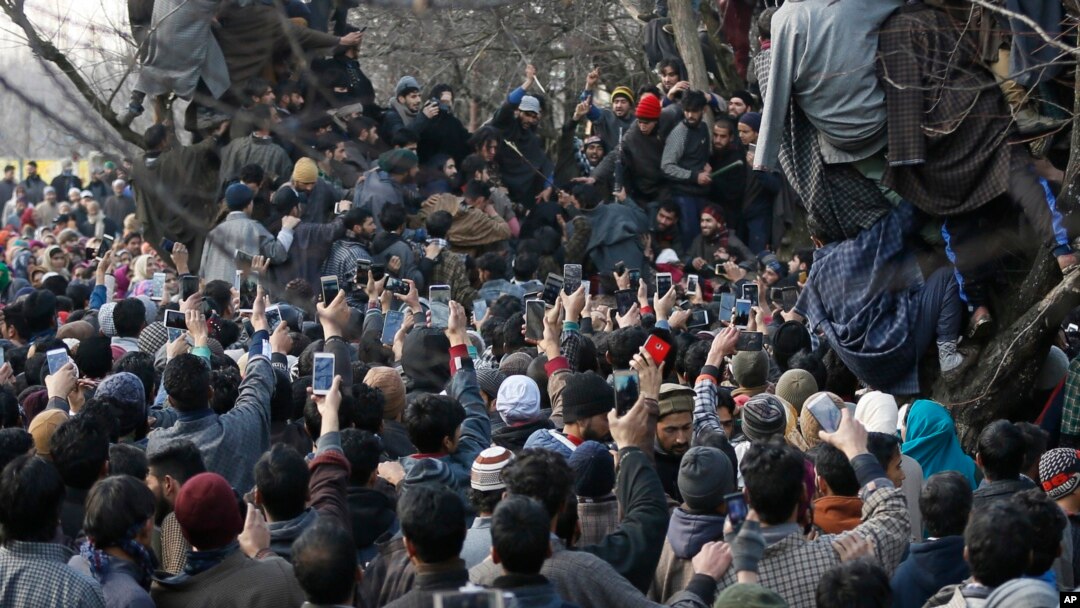 Kashmiri villagers use mobile phones to record the funeral of rebel commander Zeenatul Islam in Sugan village 61 kilometers (38 miles) south of Srinagar, Indian-controlled Kashmir, Jan. 13, 2019. 