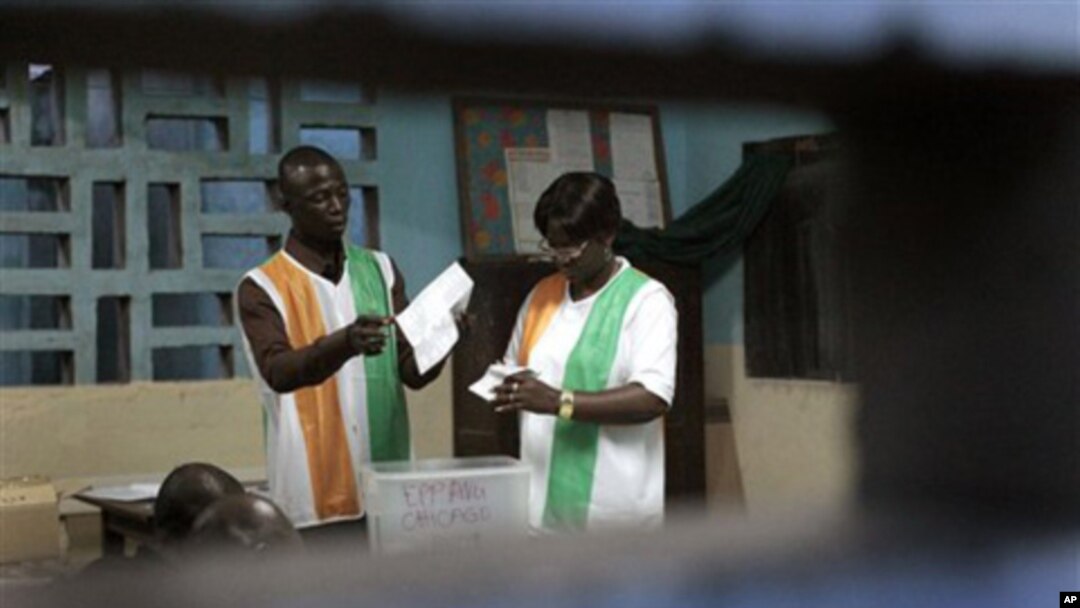 Election officials start counting ballots in the first round of presidential elections in Abidjan, Ivory Coast, Sunday Oct. 31, 2010.
