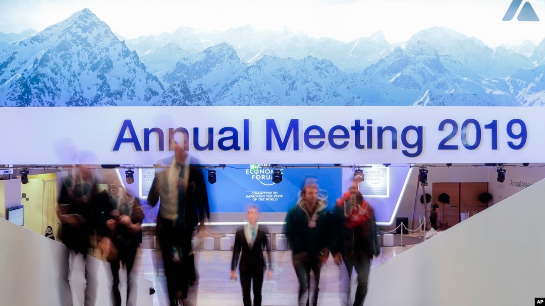 People walk up stairs at the congress center where the annual meeting of the World Economic Forum 2019, WEF, take place in Davos, Jan. 20, 2019. 