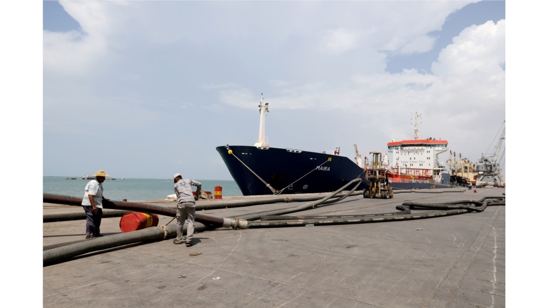 FILE - Workers prepare to unload a fuel shipment from an oil tanker at the port of Hodeida, Yemen, Oct. 17, 2019.