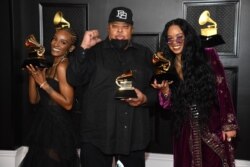 In this handout photo courtesy of The Recording Academy, (L-R) Tiara Thomas, Jeff Robinson, and H.E.R., winners of Song of the Year for "I Can't Breathe", poses in the media room during the 63rd Annual GRAMMY Awards in Los Angeles, California, March 14, 2021.