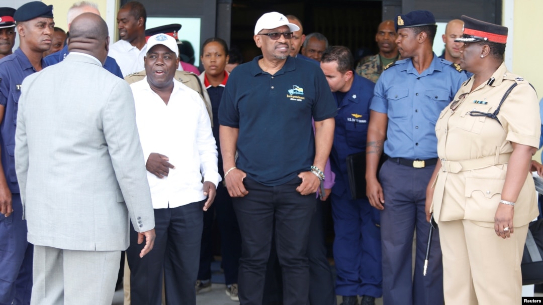 FILE - Prime Minister Huber Minnis, center, and opposition leader Philip Davis, left, prepare to board a US Coast Guard plane to survey damage caused by Hurricane Dorian in Nassau, Bahamas, Sept. 3, 2019. (John Marc Nutt/Reuters)