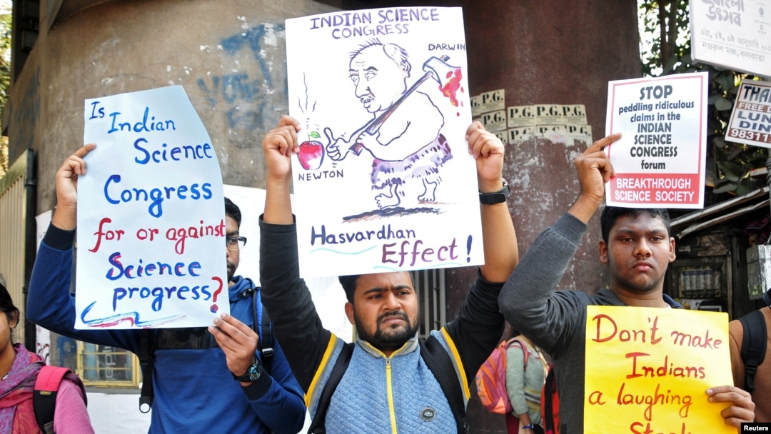 People hold placards to protest claims made by speakers, discrediting theories of Isaac Newton and Albert Einstein, at the 106th Indian Science Congress in Kolkata, India, Jan. 7, 2019.