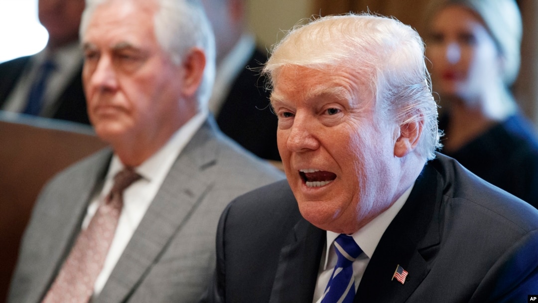 FILE - Secretary of State Rex Tillerson, left, listens as President Donald Trump speaks during a Cabinet meeting at the White House, Nov. 20, 2017, in Washington.