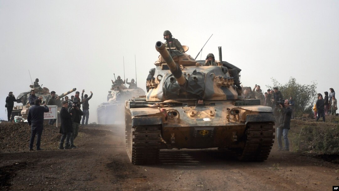 Turkish army tanks enter Afrin, an enclave in northern Syria controlled by U.S.-allied Kurdish fighters, in Hassa, Hatay, Turkey, Jan. 22, 2018. 