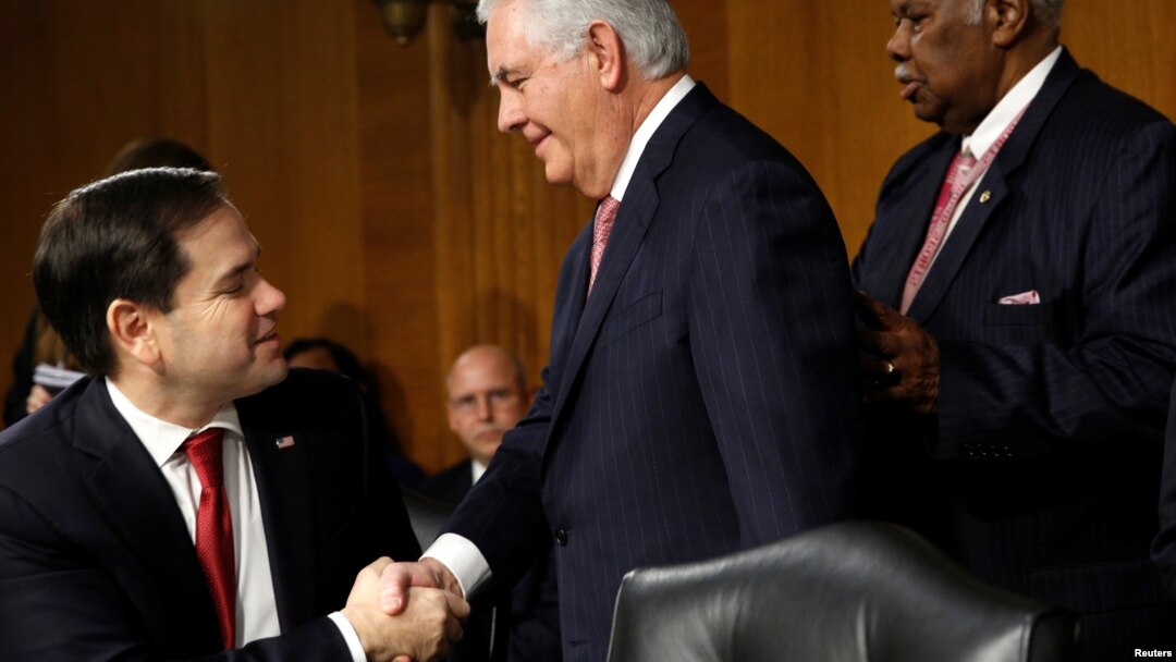 FILE - Rex Tillerson (C), the former chairman and chief executive officer of Exxon Mobil, shakes hands with U.S. Senator Marco Rubio (R-FL) as he arrives for a Senate Foreign Relations Committee confirmation hearing to become U.S. Secretary of State on Ca